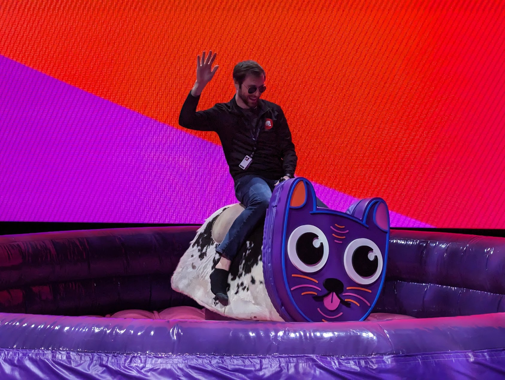 Ryan riding a mechanical bull-cat at RE:Invent